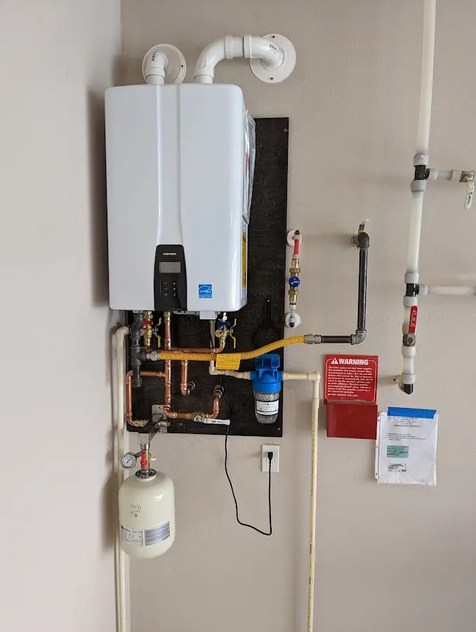 Professional plumber installing copper piping in a Metzger home